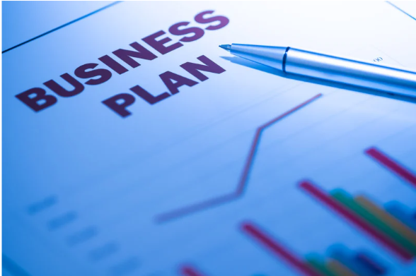 Business plan document image showing BUSINESS PLAN text on blue paper with blue pen and colorful charts/graphs in background, professional business planning theme suitable for international business plan background